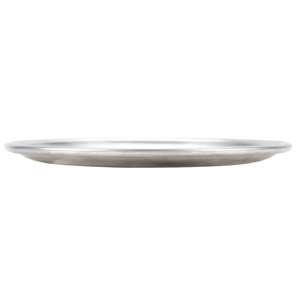 An American Metalcraft aluminum coupe pizza pan on a white table.