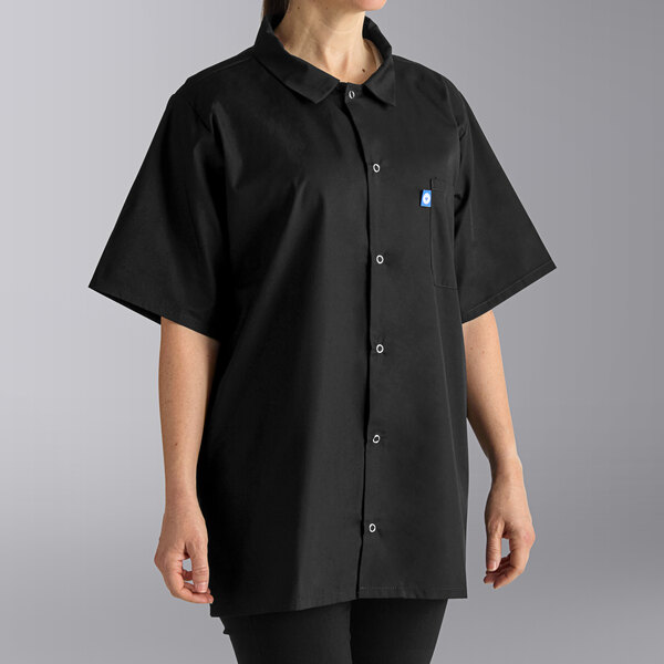 A woman wearing a black Uncommon Chef cook shirt.