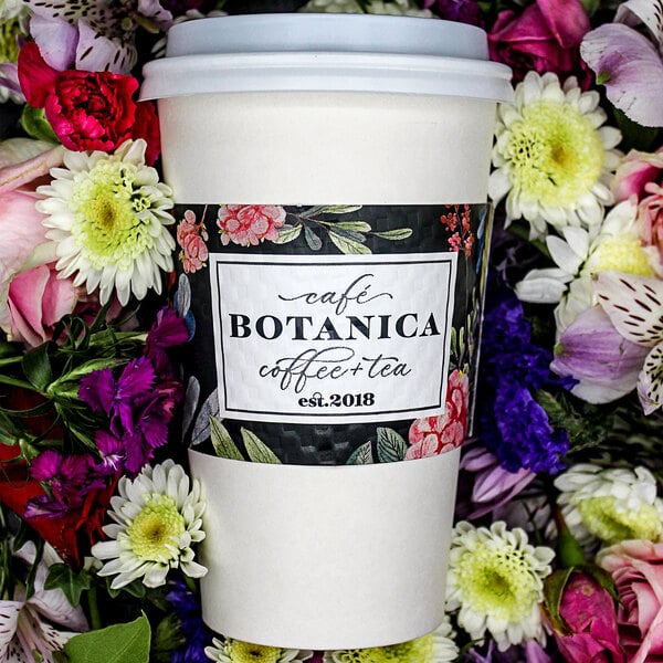 A white customizable coffee cup sleeve with a label on it.