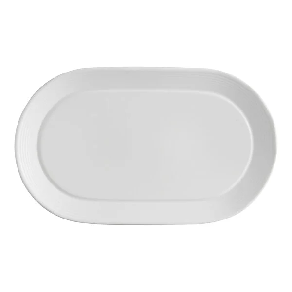 A white oval porcelain platter with embossed lines and a wide rim.