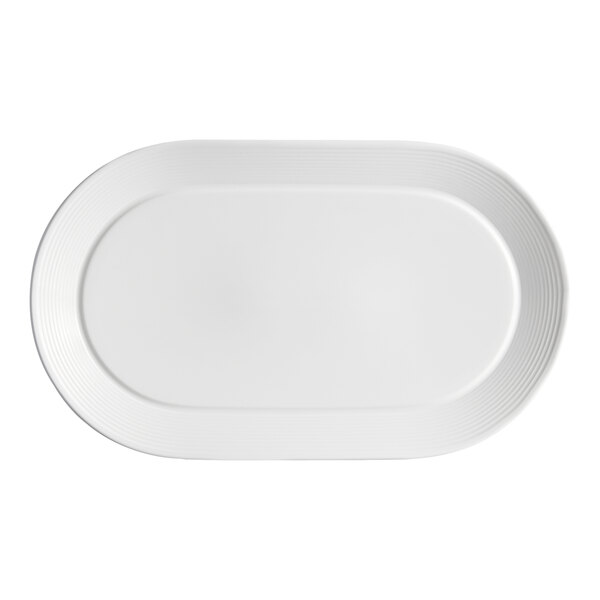 A white oval porcelain platter with embossed lines along the wide rim.