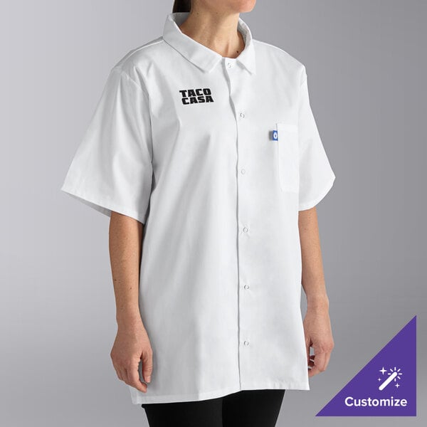 A woman wearing a white Uncommon Chef cook shirt with black and white logo.