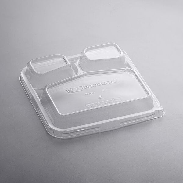 A clear plastic lid with three compartments on top of a clear plastic container.