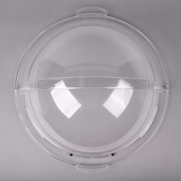 A clear plastic round cover with a circular hole.