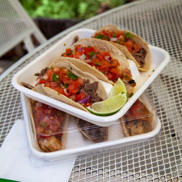 A compostable clear PLA lid designed to fit a 7-inch by 7-inch 3-compartment taco tray take-out container.
