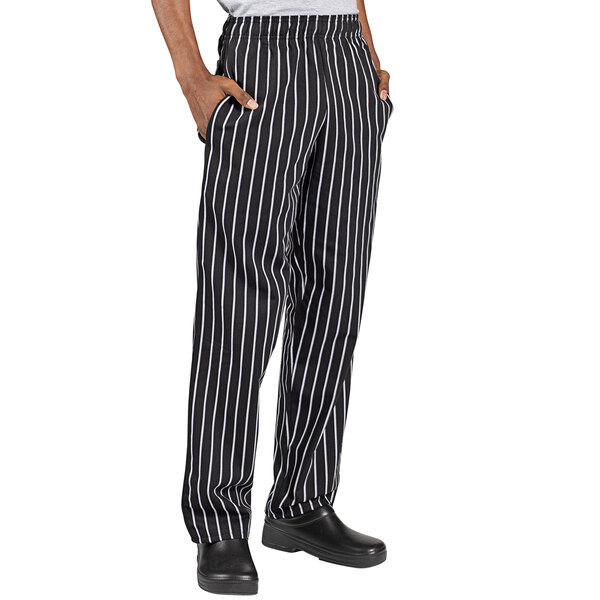 A person wearing Uncommon Chef black and white striped pants.