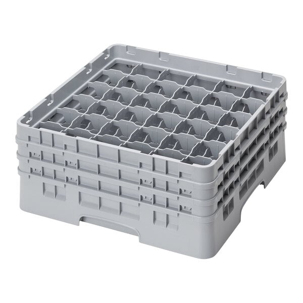 A stack of gray plastic Cambro glass racks with six compartments.