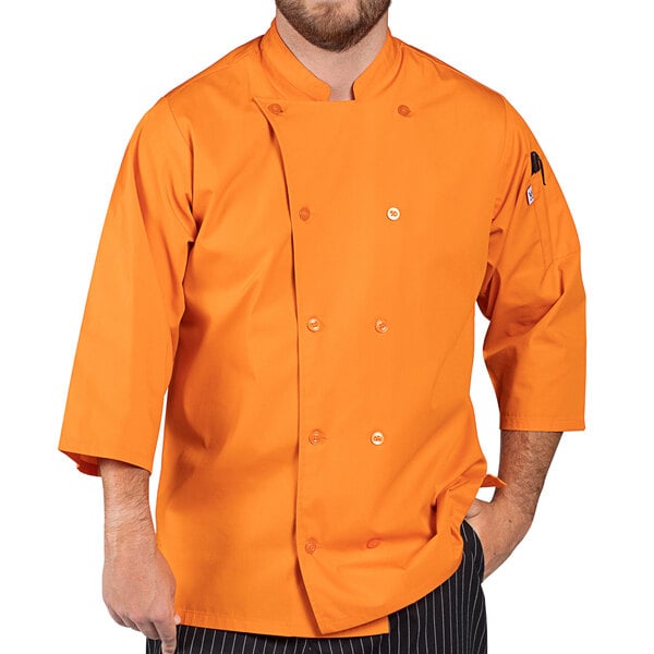 a man wearing an orange chef coat