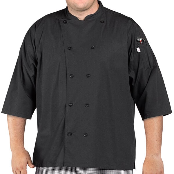 A man wearing a black Uncommon Chef 3/4 length sleeve chef coat with side vents.