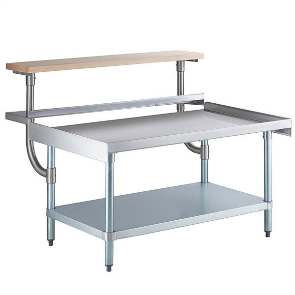 A Regency stainless steel equipment stand with a galvanized shelf and wooden cutting board.