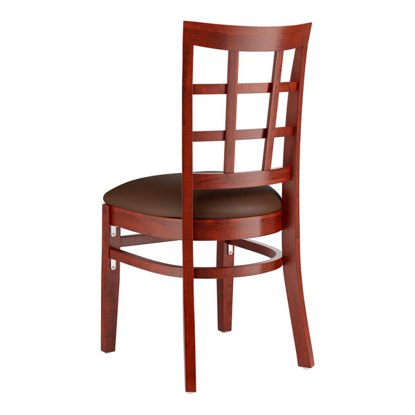 A Lancaster Table & Seating wooden chair with a dark brown vinyl cushion.