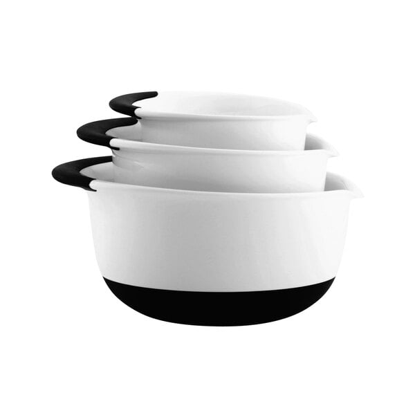A stack of white OXO mixing bowls with black non-slip bases.