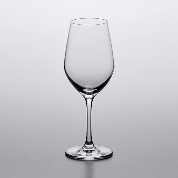 An empty Lucaris Riesling wine glass on a white surface.