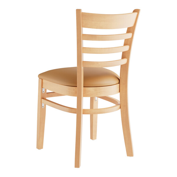 A Lancaster Table & Seating wooden restaurant chair with a light brown cushion seat and ladder back.