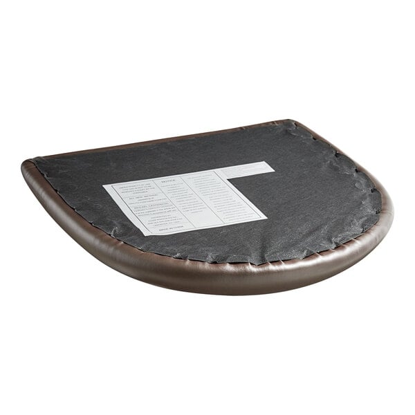 A Lancaster Table & Seating mahogany wood chair with a dark brown vinyl cushion and a piece of paper on it.