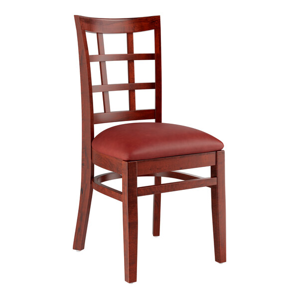 A Lancaster Table & Seating wooden chair with a burgundy vinyl cushion.