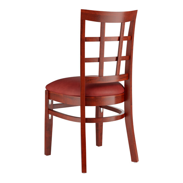 A Lancaster Table & Seating mahogany wood chair with a burgundy cushion on the seat and a window back.