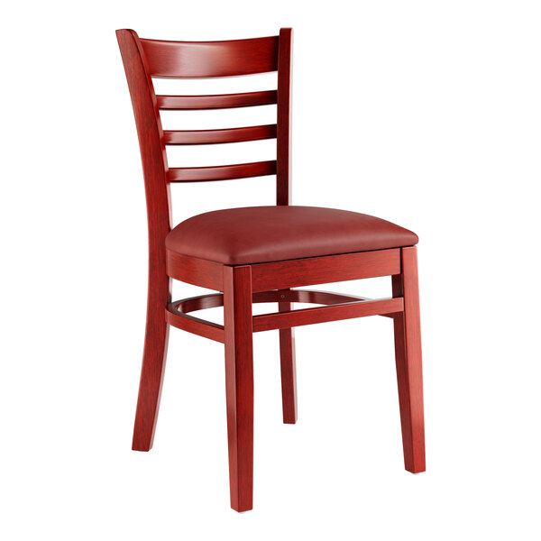A Lancaster Table & Seating mahogany wood ladder back chair with a burgundy vinyl seat.