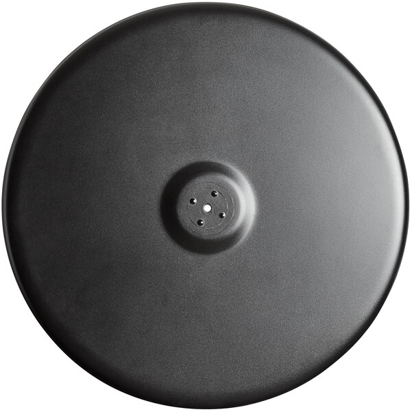 A black circular Lancaster Table & Seating Excalibur outdoor table base plate with a hole in the center.