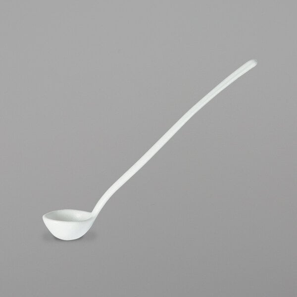 A white ladle with a long handle.