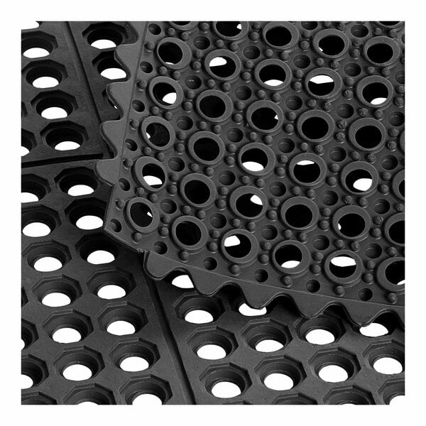 A close-up of a black Choice rubber anti-fatigue floor mat with holes.