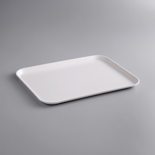 A white rectangular MFG Tray on a gray surface.