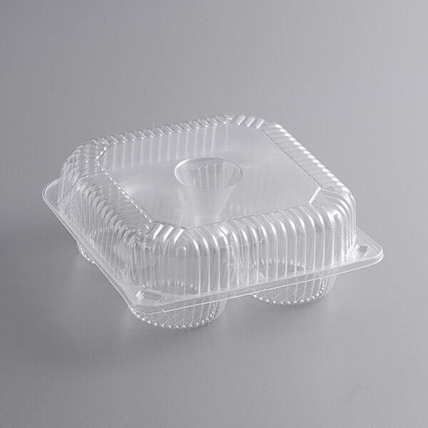 A clear plastic container with four compartments and a lid.