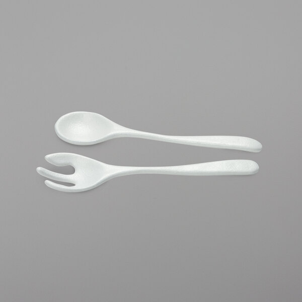 Two white plastic spoons and forks with G.E.T. Enterprises Nancy resin-coated aluminum salad servers.