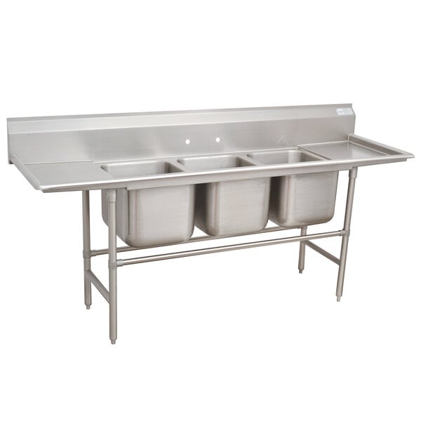 A stainless steel Advance Tabco three compartment pot sink with two drainboards.