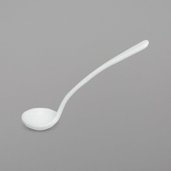 A white ladle with a long handle.