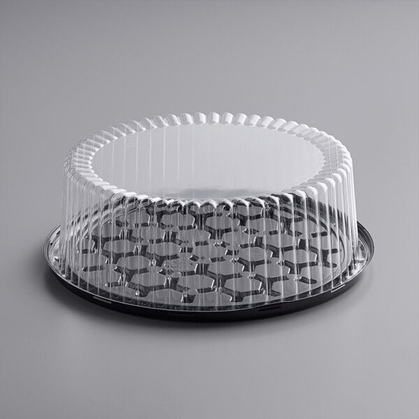 A Choice clear plastic container with a clear dome lid over a cake.