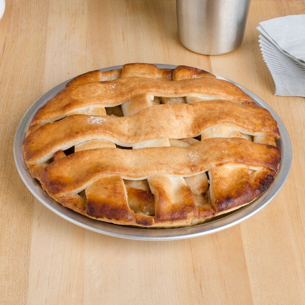 An American Metalcraft aluminum pie pan holding a pie with a lattice top on a table.