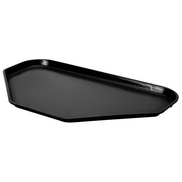 A black trapezoid-shaped MFG Tray on a counter.