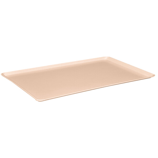 A peach rectangular MFG Tray on a counter.