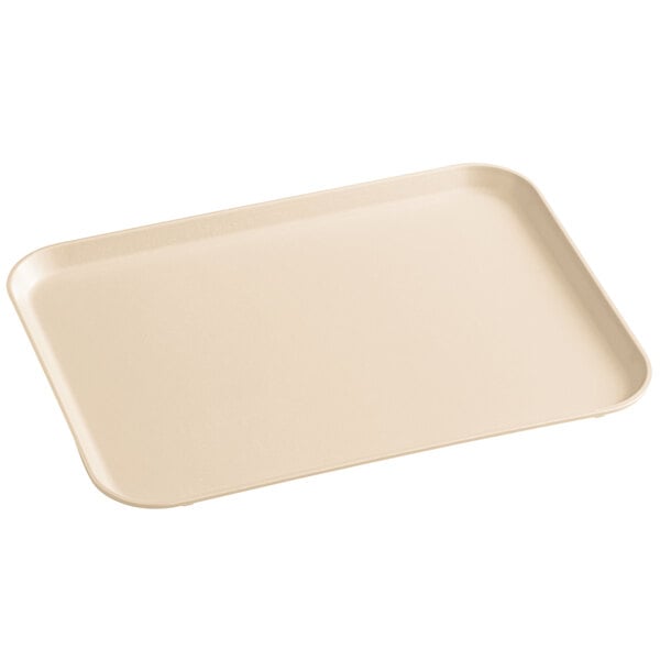 A beige rectangular MFG Tray on a counter.