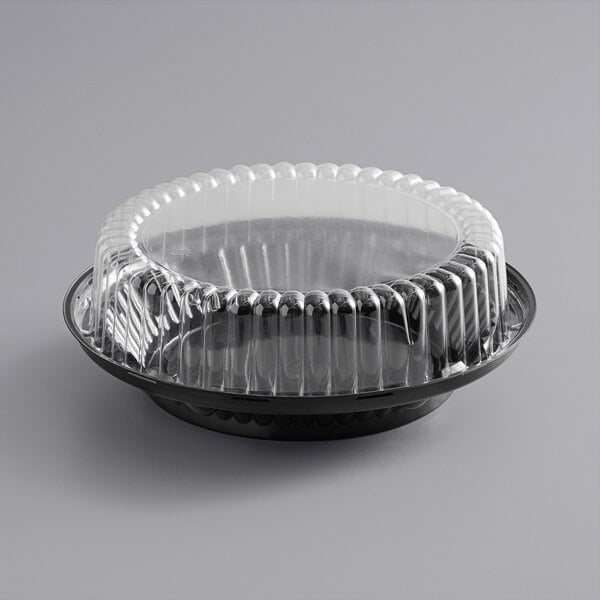 A black plastic Choice pie container with a clear lid.