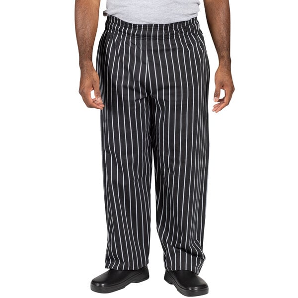 A person wearing Uncommon Chef black and white striped pants.