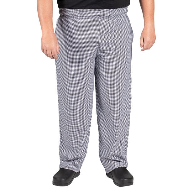 A person wearing Uncommon Chef houndstooth chef pants.