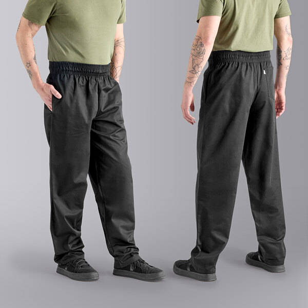 The lower half of a man wearing Uncommon Chef black pants and a green shirt.