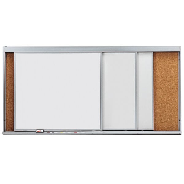 A white rectangular cork board with a black and silver frame and 3 white rectangular marker boards.