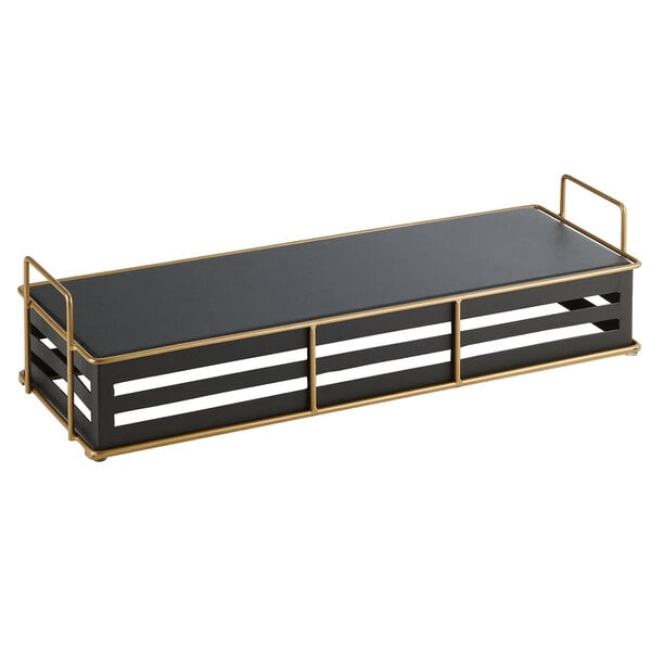 A black rectangular metal riser with gold trim on two shelves.