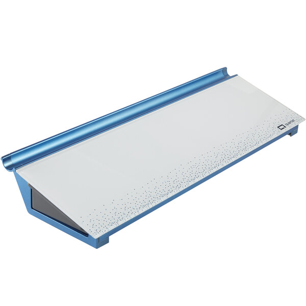 A white rectangular Quartet glass desktop pad with blue dots.