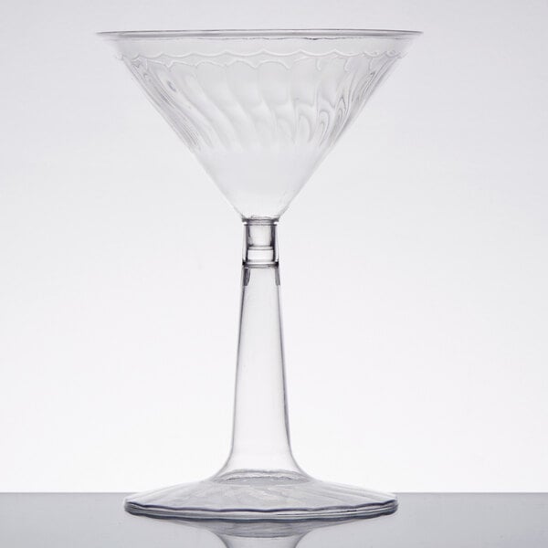 A Fineline Flairware clear plastic martini glass with a curved stem.