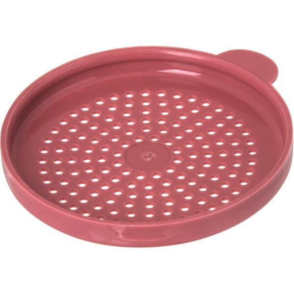 A red plastic lid with holes.
