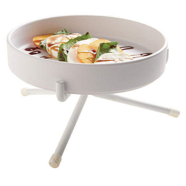 A white plate of food on a Cal-Mil Monterey plate stand.