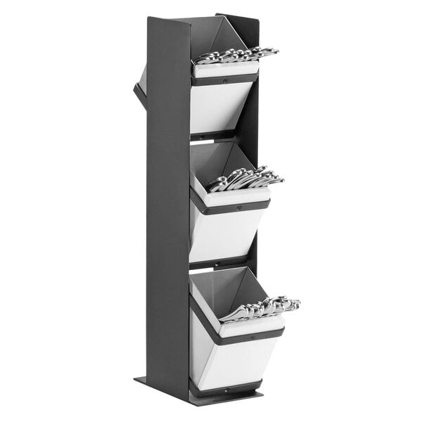 A black metal Cal-Mil Monterey flatware display rack with three baskets holding silverware.