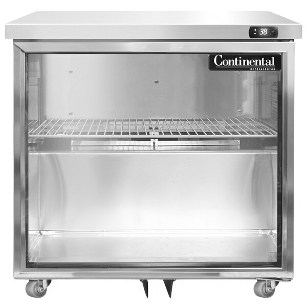 A Continental Undercounter Refrigerator with a glass door on a counter.