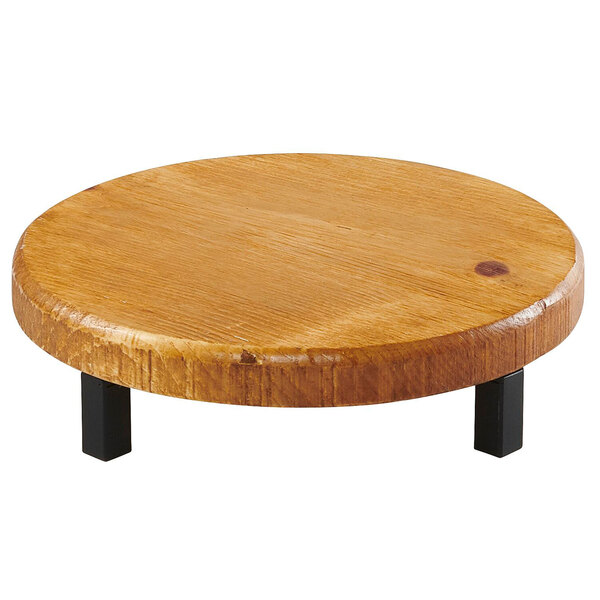 A Cal-Mil Madera rustic pine round wood riser with black legs.