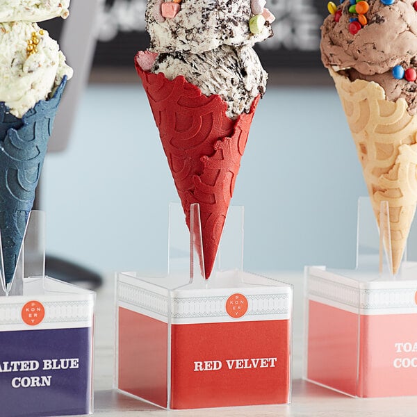 A close-up of a red velvet waffle ice cream cone.