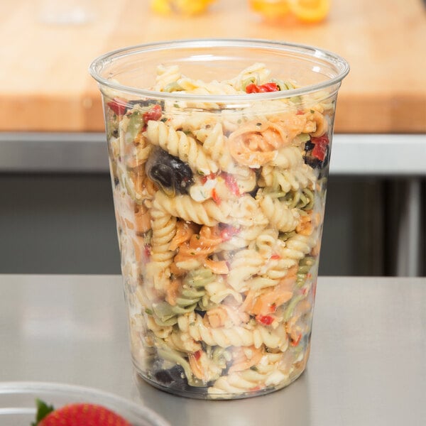 A Fabri-Kal clear plastic deli container filled with pasta.